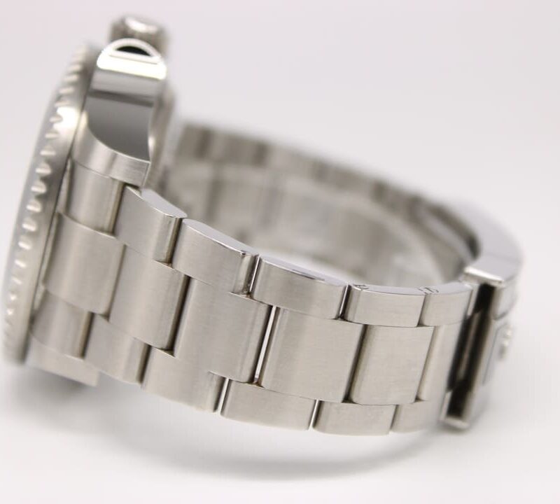 Close-up of a silver stainless steel watch bracelet, showing brushed links and a partial bezel on the left.